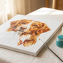 A partially painted paint by numbers canvas showing a dog portrait, with numbered paint pots and a fine brush resting alongside it on a linen surface