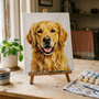 Custom paint by numbers kit of a golden retriever from a photo, on a wooden easel beside numbered paint pots in a sunny room