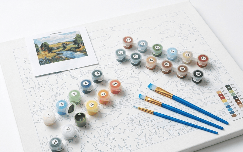 Paint by numbers kit supplies flatlay — acrylic paint pots, brushes, and numbered canvas styled