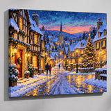 Christmas village paint by numbers kit: finished painting of a snowy village street at dusk with glowing windows and a lit Christmas tree