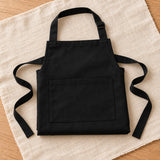 Black painter's apron folded on linen