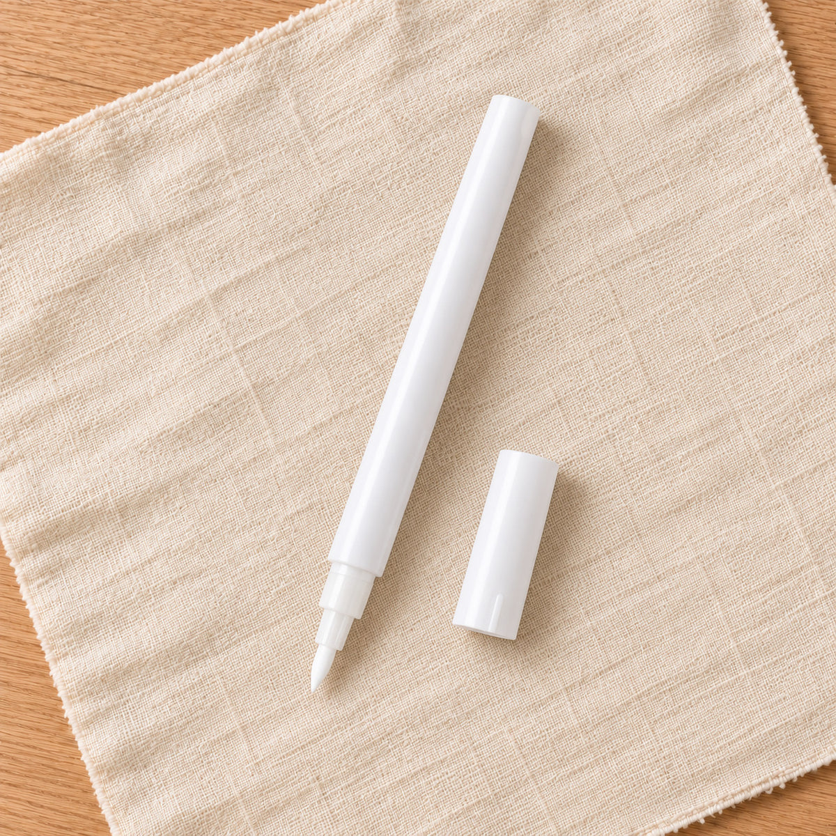 White fine-tip acrylic paint pen with cap